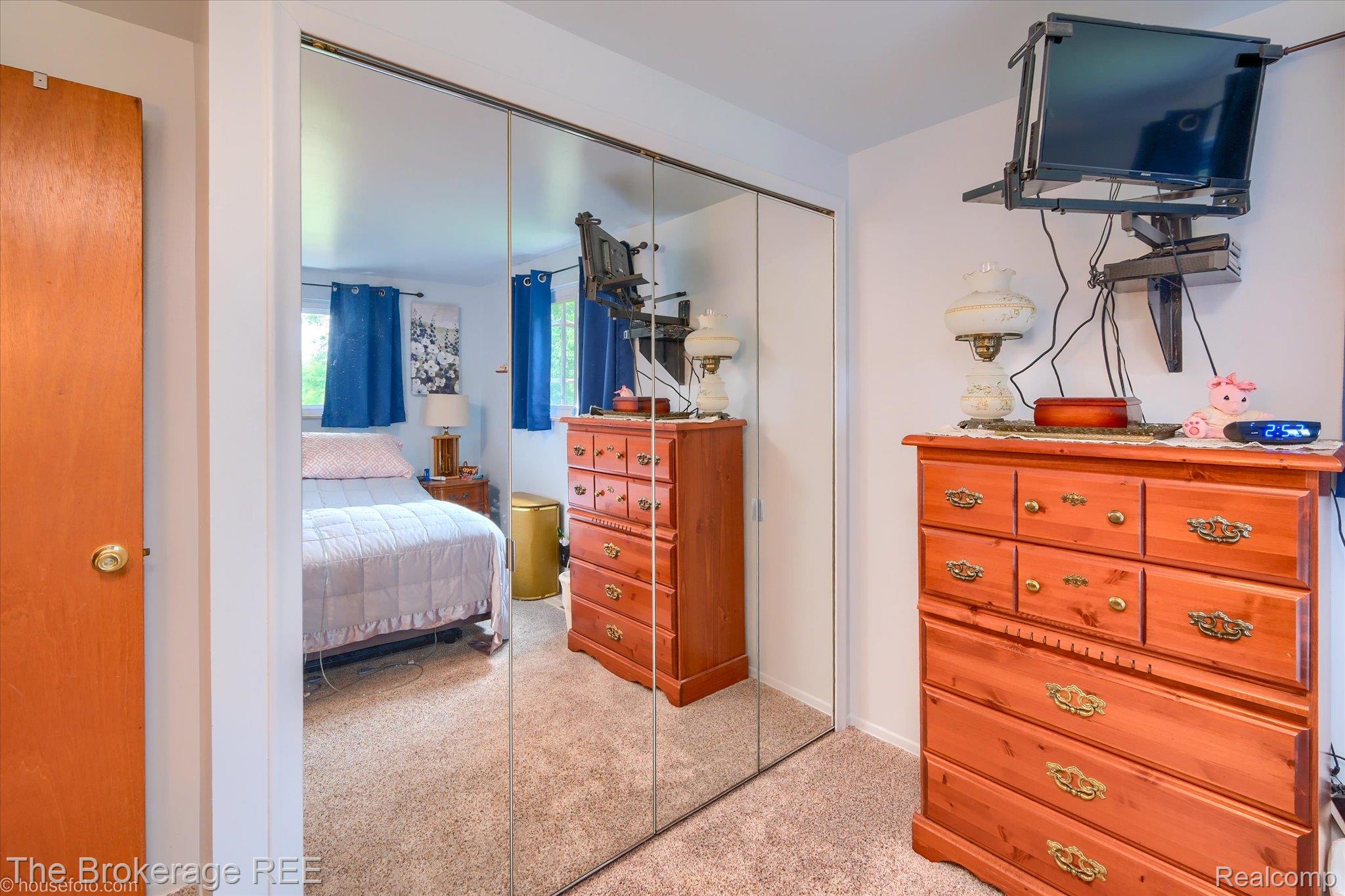 6129 East Lake Road Millington, MI 48746 - Photo 24 of 47 Bedroom with light carpet and a closet