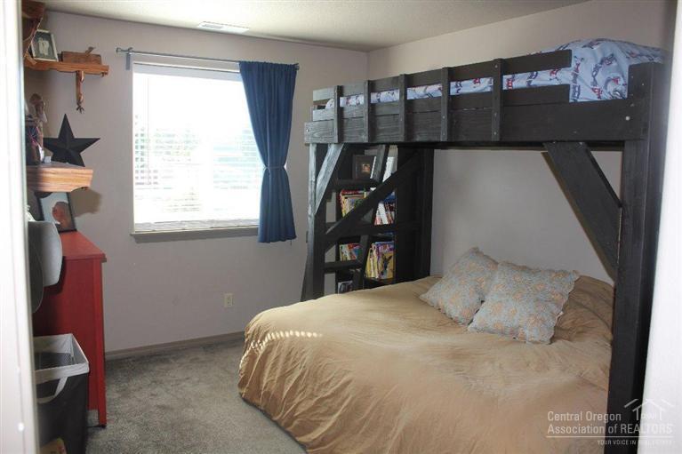 63263 Vogt Road Bend, OR 97701 - Photo 10 of 16 a bedroom with a bed and a window