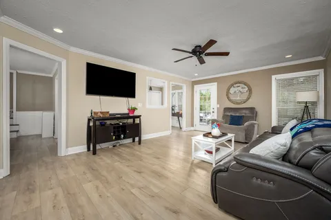 a living room with furniture and wooden floor