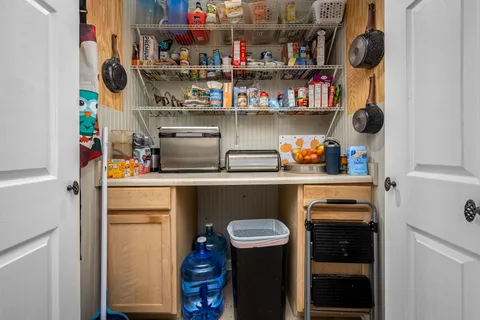 a large kitchen with kitchen island granite countertop a large counter top appliances and a sink