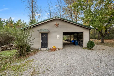 a view of a house with a yard and garage