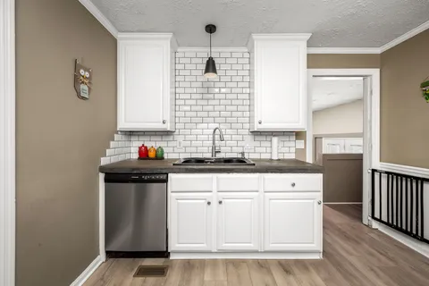 a living room with furniture a rug and a window