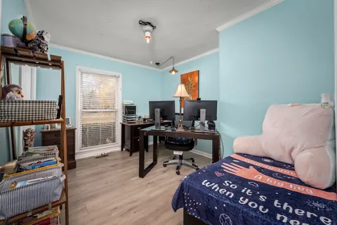a bedroom with a bed and a chandelier