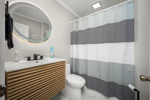 a bathroom with a toilet and a shower