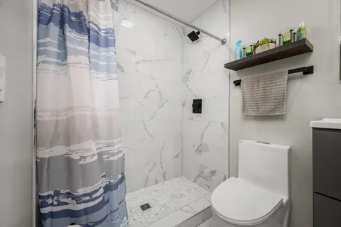 a utility room with dryer washer and shoe rack