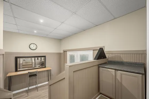 a view of deck with furniture and barbeque oven in the backyard