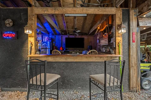 a patio with a table and chairs under an umbrella