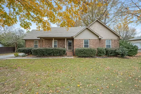 a house that has a tree in front of it