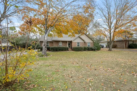 a front view of house with yard and green space