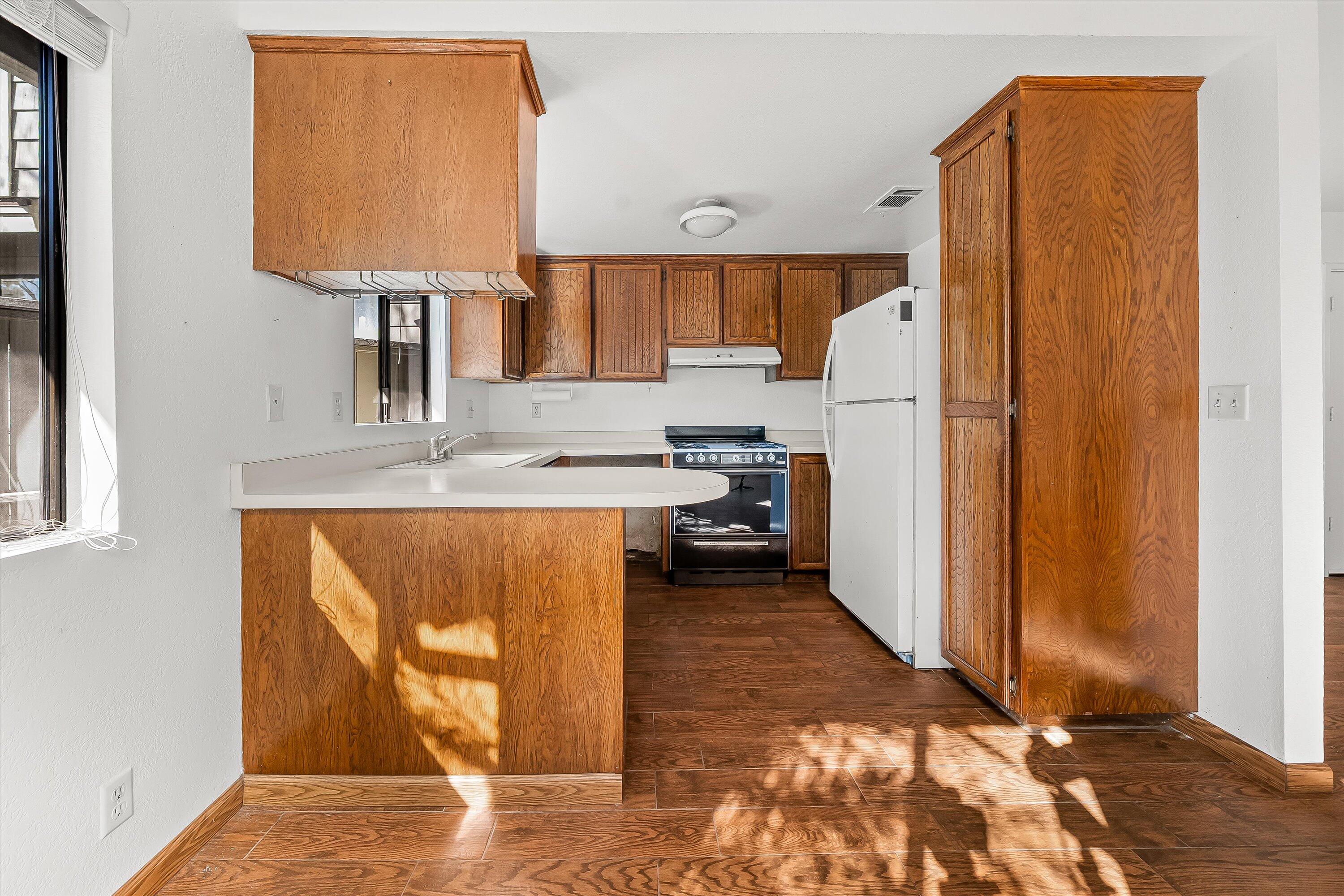 522 West Victoria Street, Unit B Santa Barbara, CA 93101 - Photo 12 of 21 a kitchen with stainless steel appliances granite countertop a refrigerator and a sink