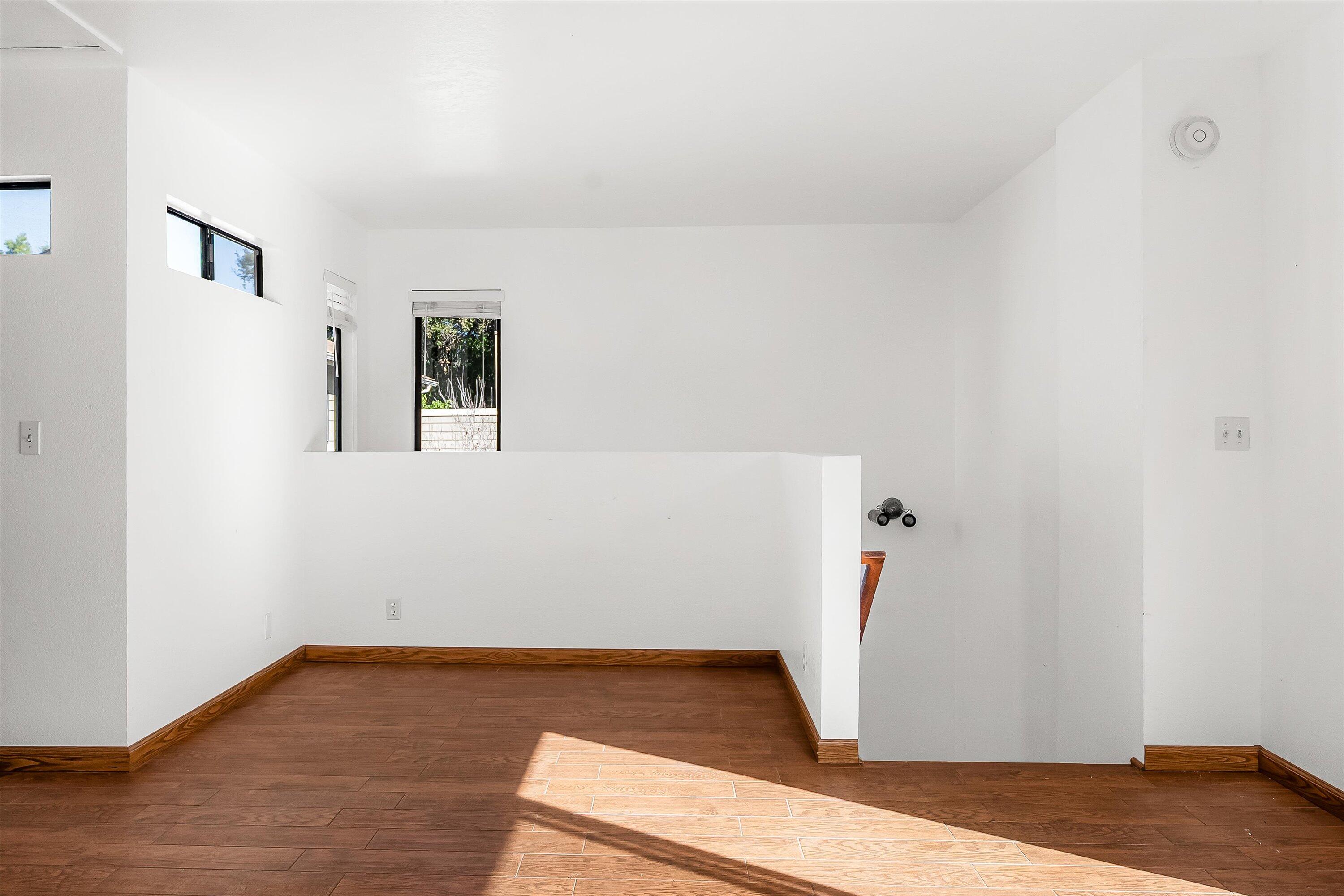 522 West Victoria Street, Unit B Santa Barbara, CA 93101 - Photo 17 of 21 a view of a room with wooden floor and white walls
