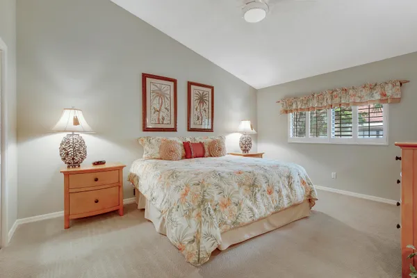 a spacious bedroom with a bed and a window