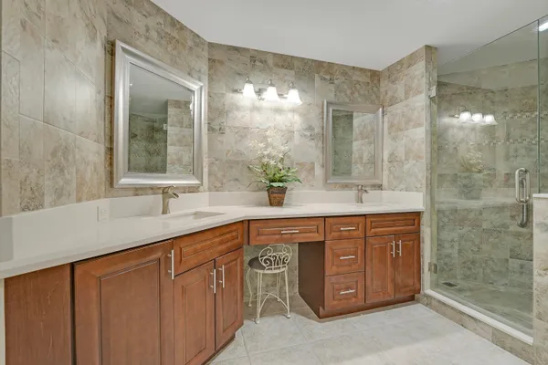 a spacious bathroom with a double vanity sink mirror and double