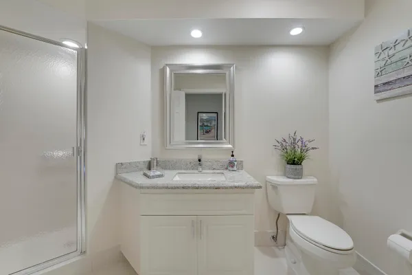 a bathroom with a toilet sink and mirror
