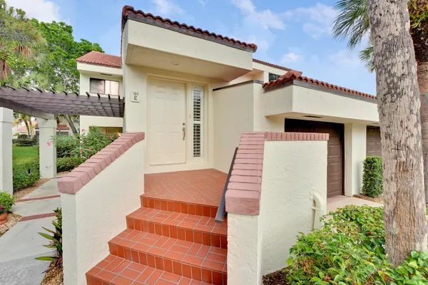 a view of a house with wooden fence and large windows