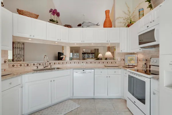 a kitchen with granite countertop a sink and cabinets