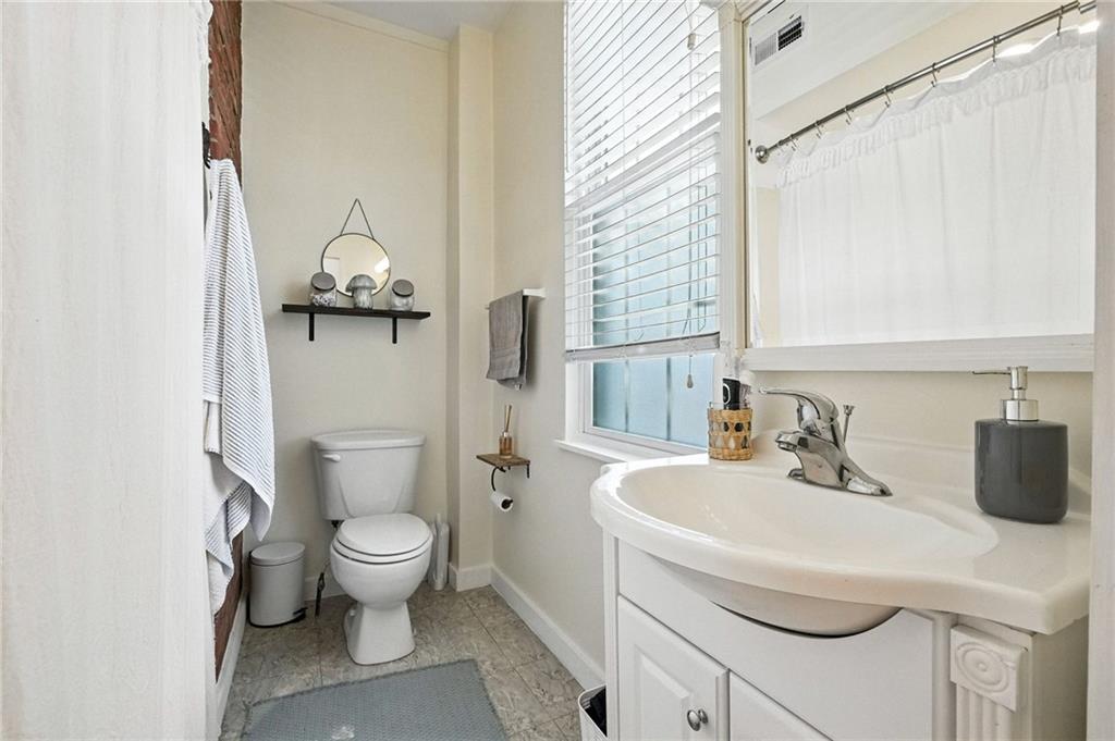 3037 Pulawski Way Pittsburgh, PA 15219 - Photo 11 of 26 a bathroom with a sink toilet and mirror