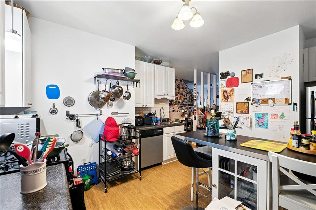 3037 Pulawski Way Pittsburgh, PA 15219 - Photo 16 of 26 a room with gym equipment and a chandelier