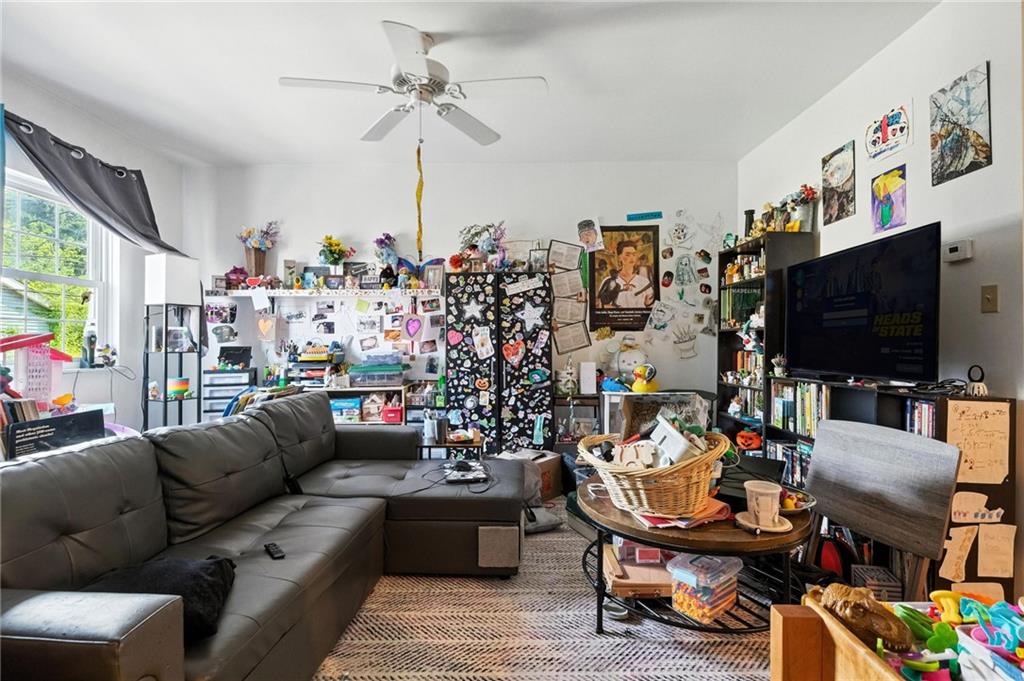 3037 Pulawski Way Pittsburgh, PA 15219 - Photo 17 of 26 a living room with furniture and a flat screen tv