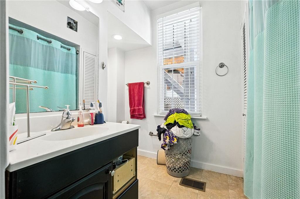 3037 Pulawski Way Pittsburgh, PA 15219 - Photo 20 of 26 a bathroom with a sink mirror and a shower