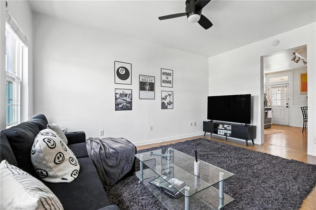 3037 Pulawski Way Pittsburgh, PA 15219 - Photo 7 of 26 a living room with furniture and a flat screen tv
