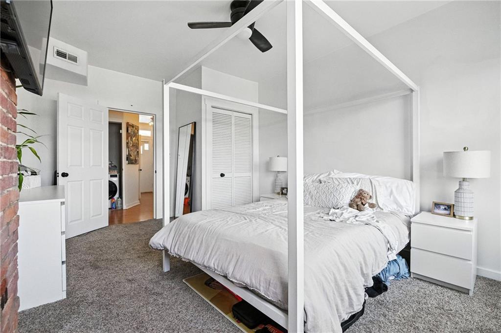 3037 Pulawski Way Pittsburgh, PA 15219 - Photo 9 of 26 a bedroom with a bed and a refrigerator