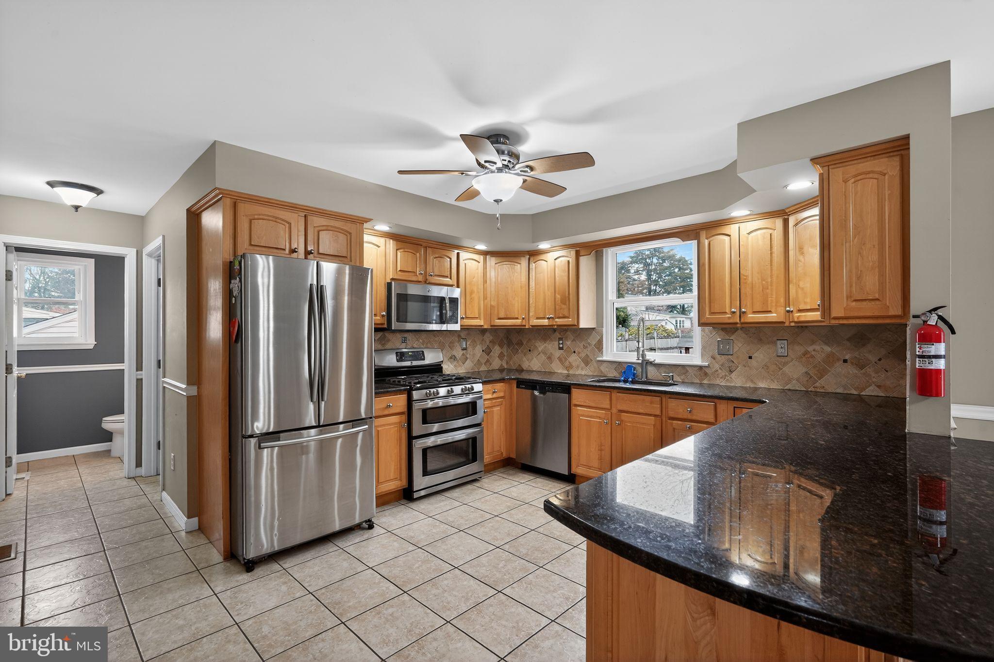 740 Carpenter Street Glassboro, NJ 08028 - Photo 13 of 44 Modern kitchen with warm wood accents.