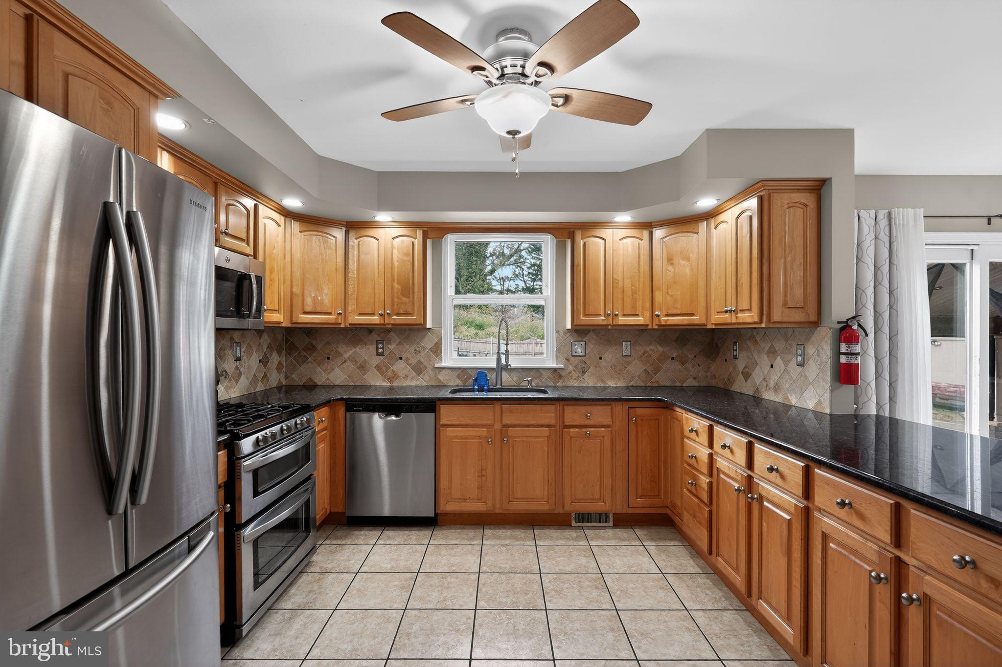 740 Carpenter Street Glassboro, NJ 08028 - Photo 15 of 44 Modern kitchen with warm wood cabinetry.