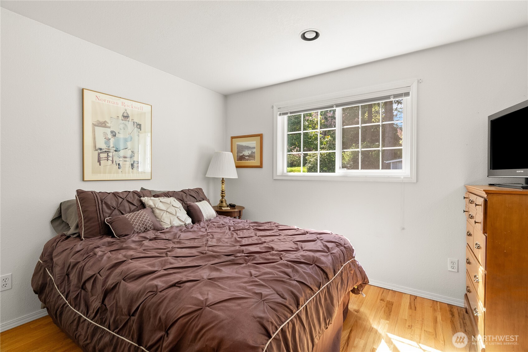 8320 East Grapeview Loop Road Allyn, WA 98524 - Photo 16 of 38 a bedroom with a bed and a flat screen tv