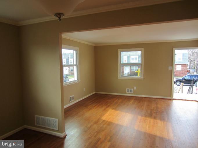 5653 Whitby Road Baltimore, MD 21206 - Photo 1 of 26 an empty room with wooden floor and windows