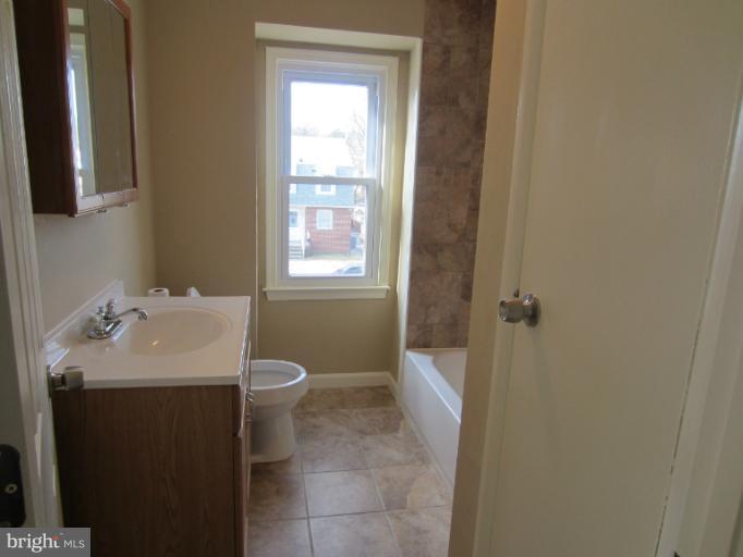 5653 Whitby Road Baltimore, MD 21206 - Photo 3 of 26 a bathroom with a sink toilet and window