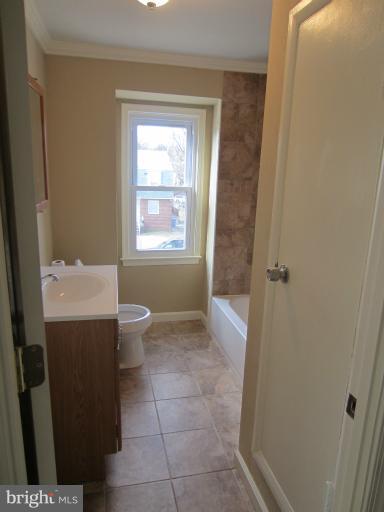 5653 Whitby Road Baltimore, MD 21206 - Photo 7 of 26 a bathroom with a sink a toilet and shower