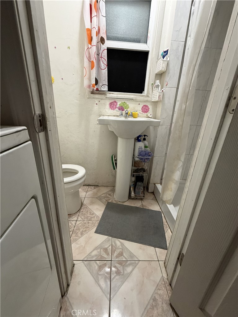 13100 Rangoon Street Arleta, CA 91331 - Photo 12 of 14 a view of bathroom with a toilet sink and mirror