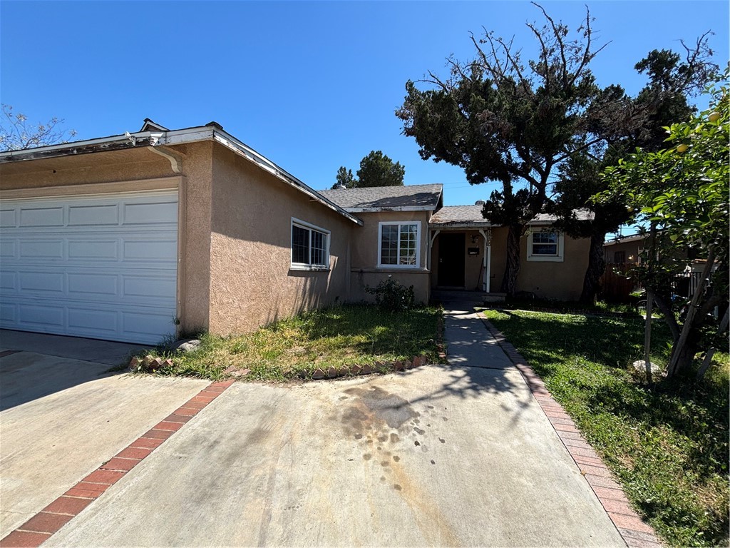 13100 Rangoon Street Arleta, CA 91331 - Photo 4 of 14 a front view of a house with a yard