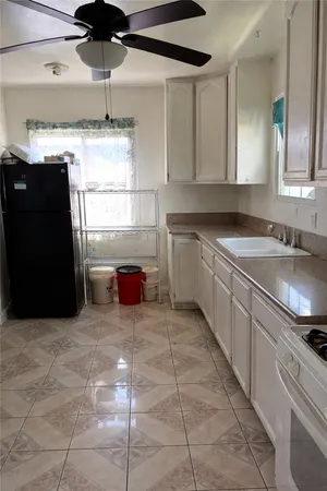 a kitchen with stainless steel appliances granite countertop a sink and a refrigerator