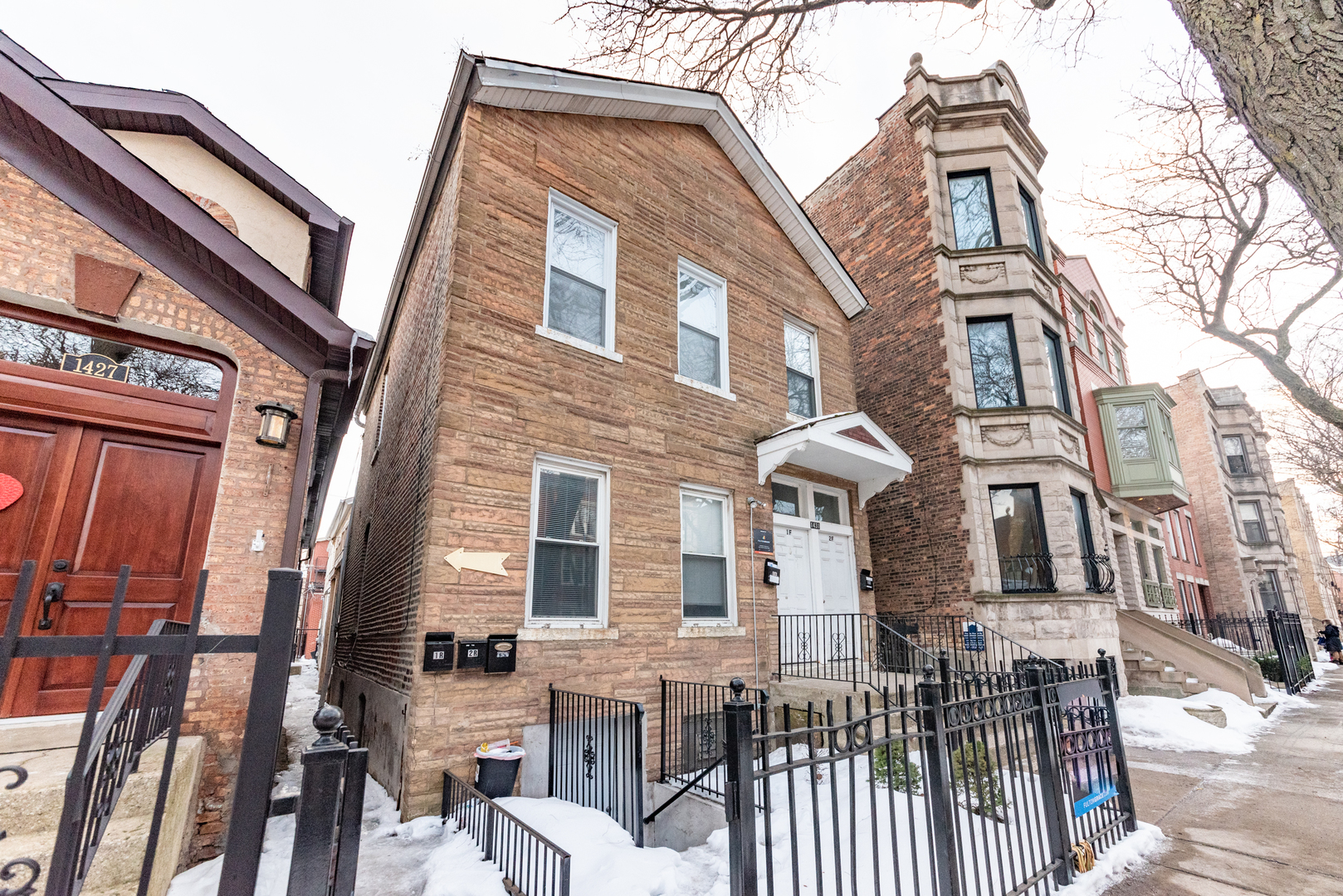 a front view of a residential apartment building with a yard