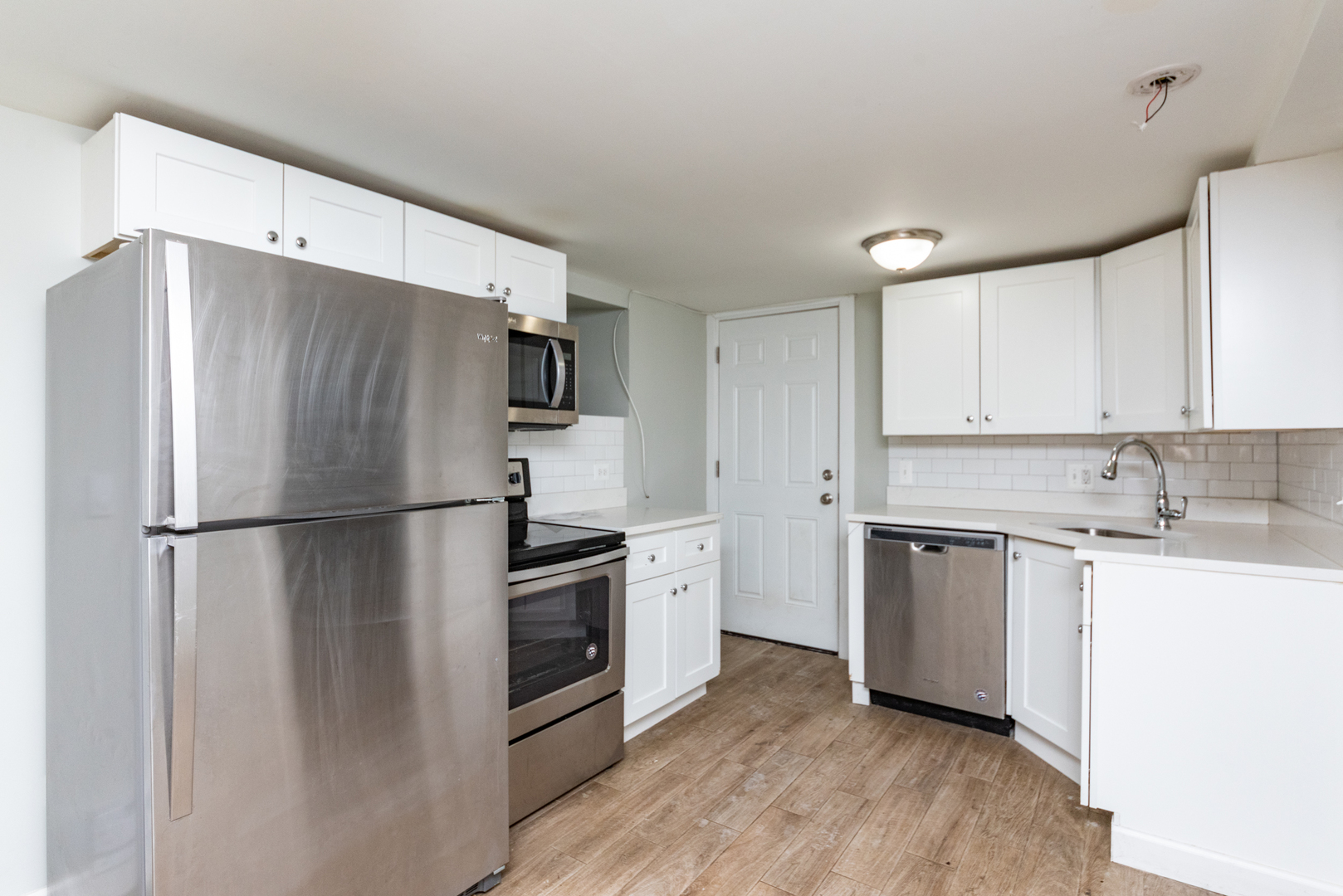 1431 West Flournoy Street, Unit G Chicago, IL 60607 - Photo 2 of 12 a white refrigerator freezer sitting inside of a kitchen
