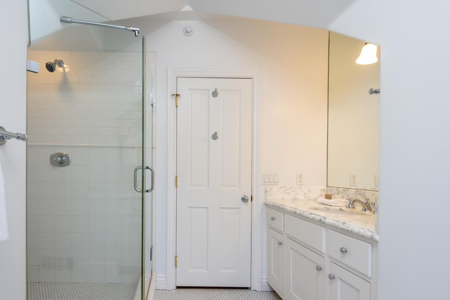 1075 Godetia Drive Woodside, CA 94062 - Photo 16 of 33 a bathroom with a granite countertop sink two mirror and shower