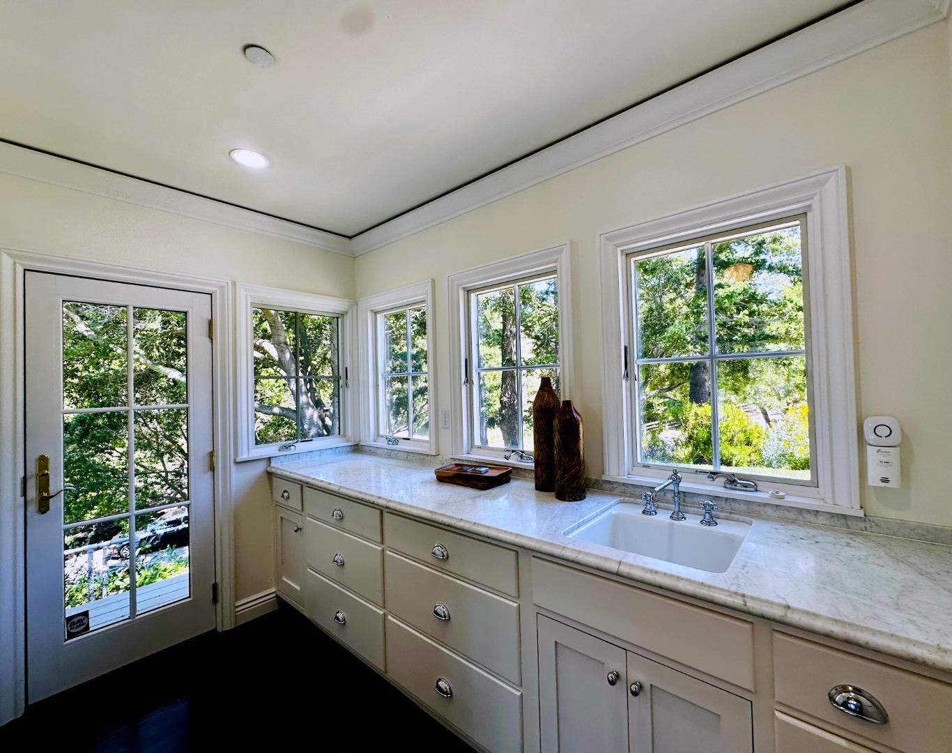 1075 Godetia Drive Woodside, CA 94062 - Photo 19 of 33 a kitchen with sink and large windows