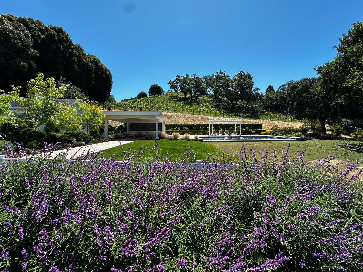 1075 Godetia Drive Woodside, CA 94062 - Photo 21 of 33 an aerial view of a house with a garden and lake view