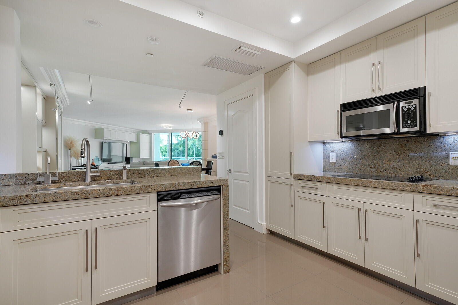 550 Southeast Mizner Boulevard, Unit B209 Boca Raton, FL 33432 - Photo 19 of 78 a kitchen with granite countertop white cabinets and stainless steel appliances