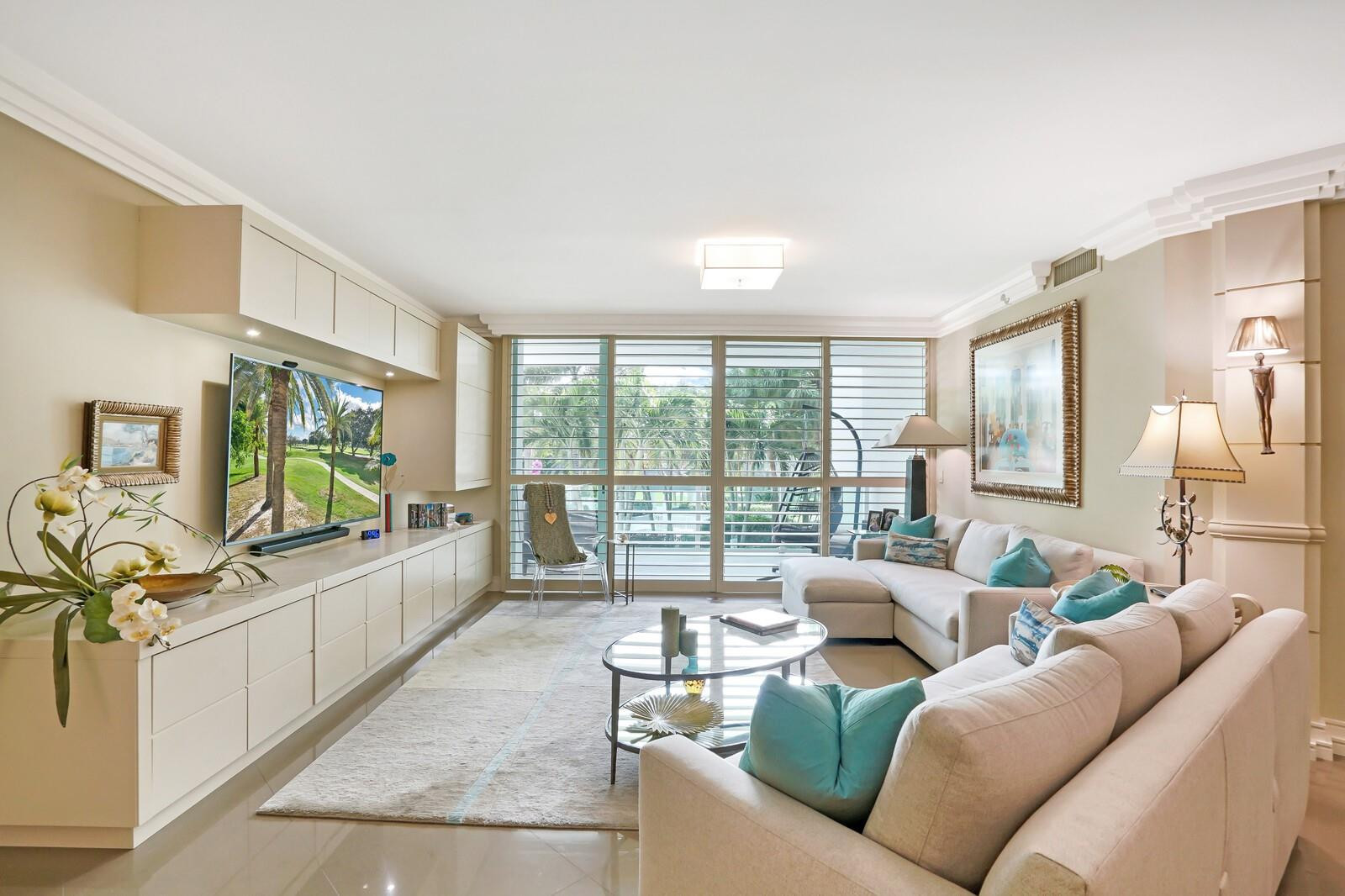 550 Southeast Mizner Boulevard, Unit B209 Boca Raton, FL 33432 - Photo 55 of 78 a living room with furniture large window and a flat screen tv