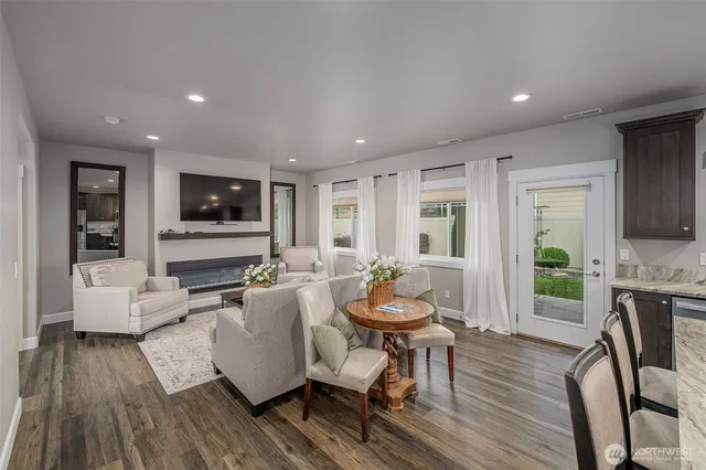 a living room with fireplace furniture and a flat screen tv