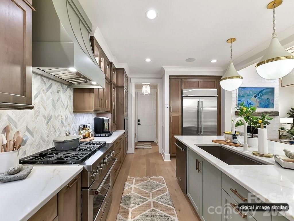 1002 Kingbird Lane, Unit 7 Clover, SC 29710 - Photo 12 of 40 a kitchen with stainless steel appliances a sink stove and cabinets