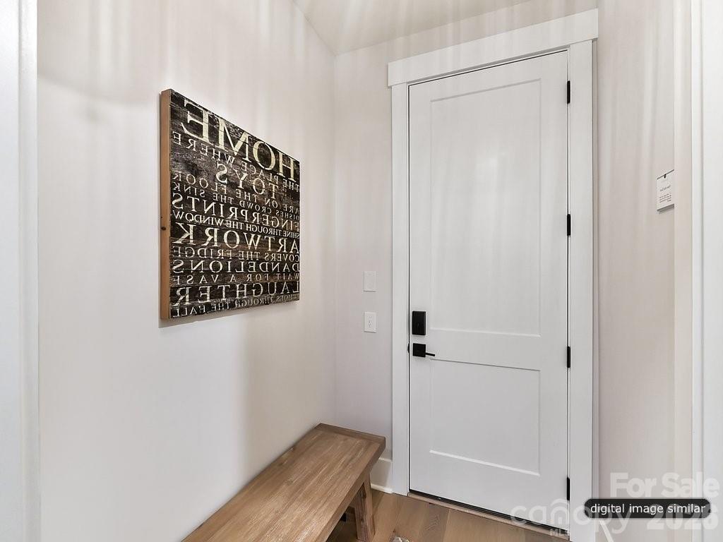 1002 Kingbird Lane, Unit 7 Clover, SC 29710 - Photo 13 of 40 a view of a hallway with wooden floor and a bathroom