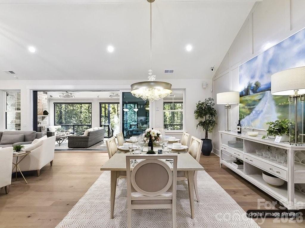 1002 Kingbird Lane, Unit 7 Clover, SC 29710 - Photo 19 of 40 a dining room with furniture a large window and a chandelier