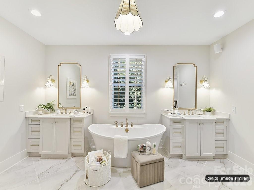 1002 Kingbird Lane, Unit 7 Clover, SC 29710 - Photo 28 of 40 a spacious bathroom with a toilet sink and mirror