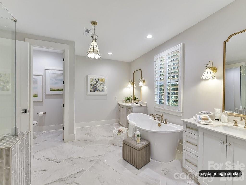 1002 Kingbird Lane, Unit 7 Clover, SC 29710 - Photo 29 of 40 a spacious bathroom with a sink double vanity and a mirror