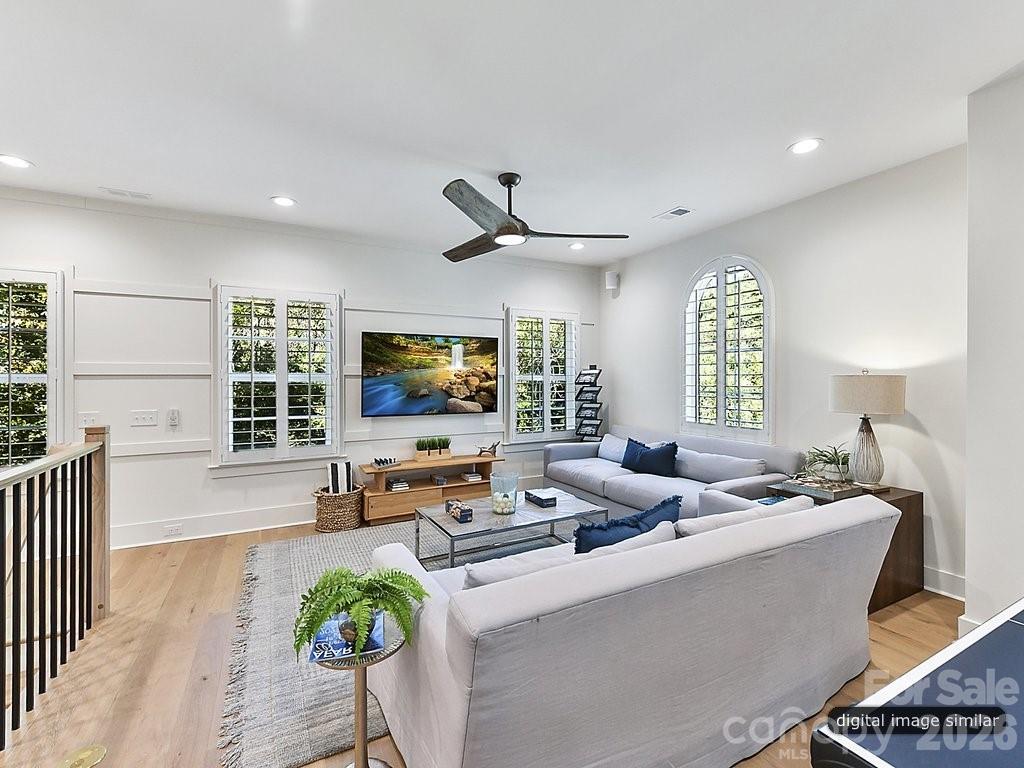 1002 Kingbird Lane, Unit 7 Clover, SC 29710 - Photo 34 of 40 a living room with furniture a flat screen tv and a large window