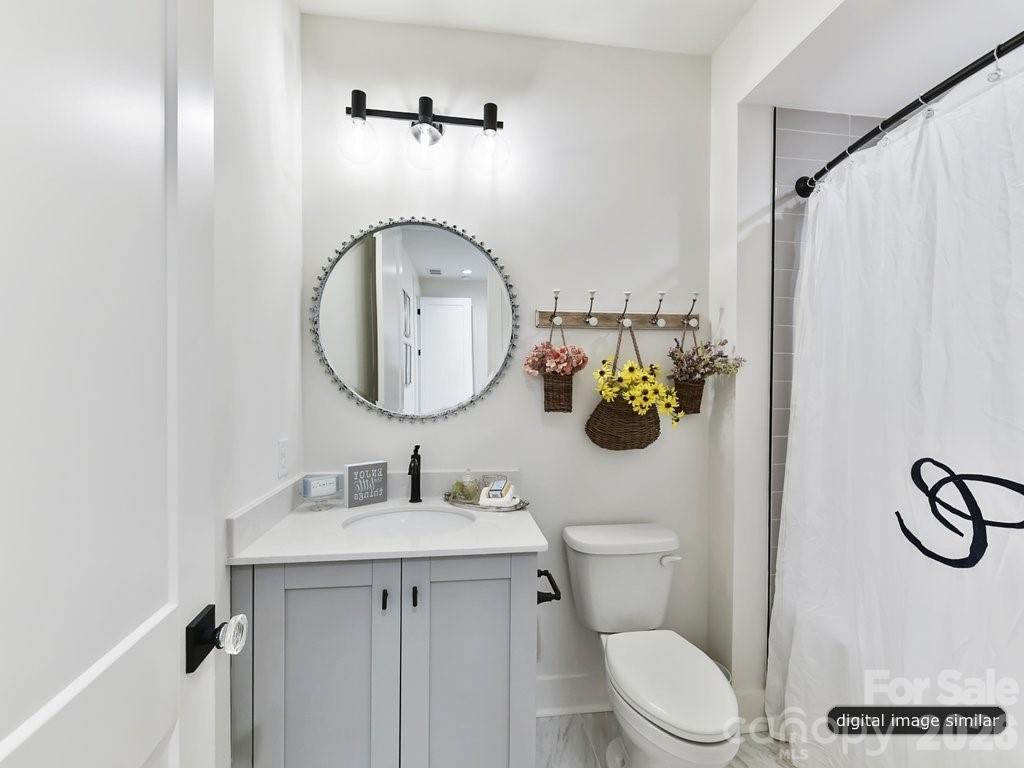 1002 Kingbird Lane, Unit 7 Clover, SC 29710 - Photo 40 of 40 a bathroom with a sink mirror vanity and toilet